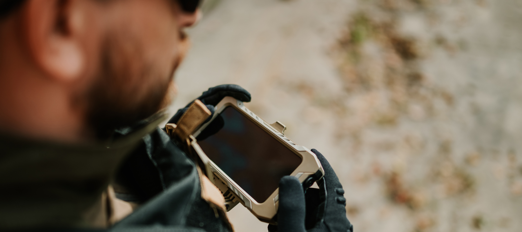 Soldier using mobile phone wearing tactical gloves and gear